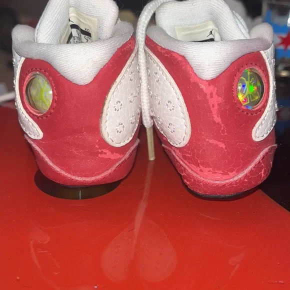 Red and white baby shoes Left side red color is peeling as shown in the pictures - Picture 2 of 7